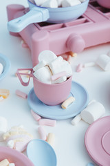 Colorful plastic dishes and marshmallows