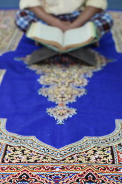 Muslim man reading the Quran in a mosque, Ho Chi Minh City, Vietnam