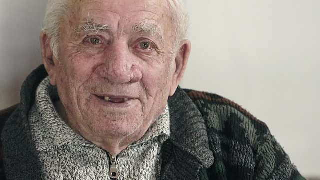 laughter of elderly man to the camera