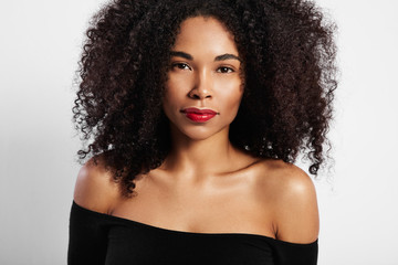 black woman watching at camera directly, curly hair