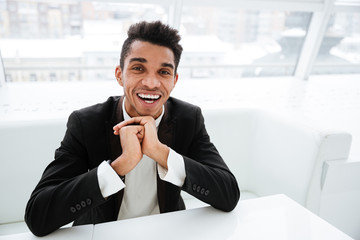 Happy african business man at the table