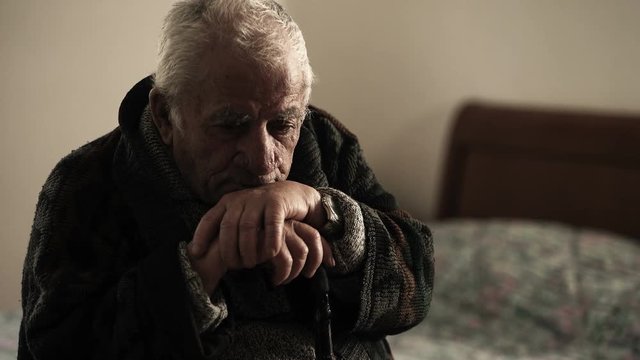Detail of sick depressed old man in nurse home