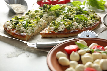 Vegetarian Italian pizza with cheese and vegetables on a paper