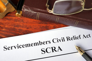 Servicemembers Civil Relief Act (SCRA) and a book. - obrazy, fototapety, plakaty