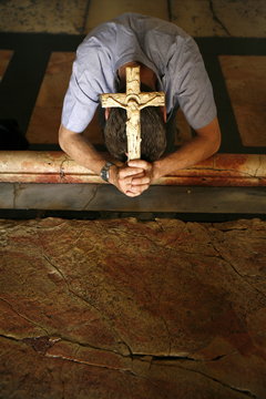 Worshipper at the Stone of the Anointing, Church of the Holy Sepulchre, Jerusalem, Israel