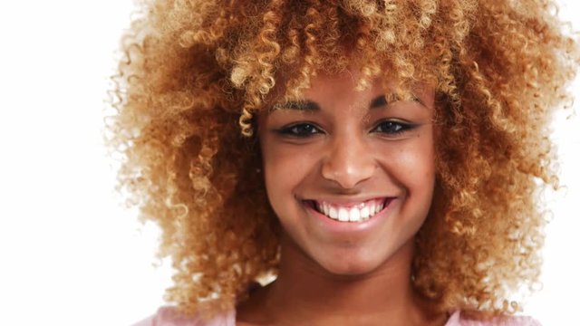 beauty black blonde woman watching at camera and touches her hair, smiling.