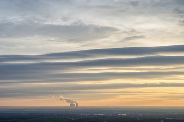 dramatic evening sky with interesting clouds over the horizon of Saxony in Germany with the Lippendorf power station with its vapor columns rising in the distance