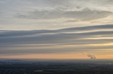 Naklejka na ściany i meble evening sky with interesting clouds during sunset over the horizon of Saxony in Germany with the Lippendorf power station in the distance