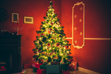 Beautiful Christmas living room with decorated Christmas tree, gifts and fireplace. The idea for postcards