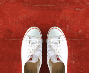 Pair of Sneakers on Wooden Floor.