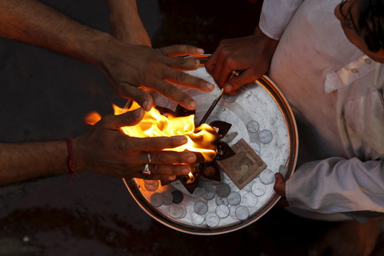 Priest and devotee performing aarti, Haridwar,Uttarakhand