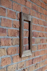old frame on brick wall