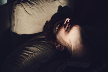 Mature woman lying on bed in pain