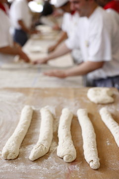 Bakers making loaves of bread (baguettes), Paris, France