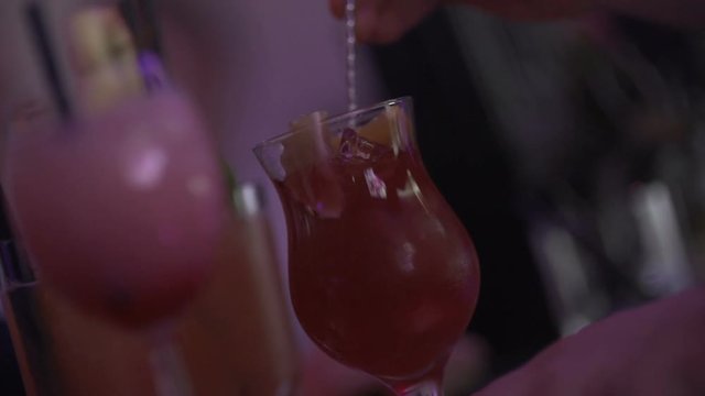 SLO MO CLOSE-UP Bartender preparing cocktail