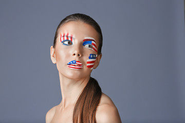 Girl with USA makeup on grey background