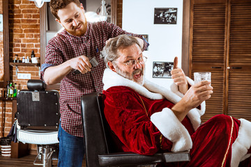 Santa claus shaving his personal barber