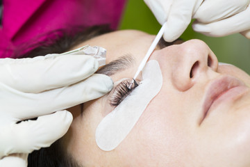 Woman on the procedure for eyelash extensions, eyelashes lamination