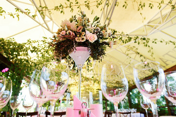 Look from below at white bouquet put in the middle of dinner tab