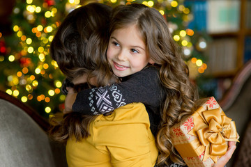 happy mother and little girl with gift box