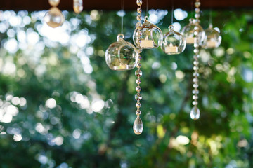 Crystal chains hang from the ceiling together with glass balls w