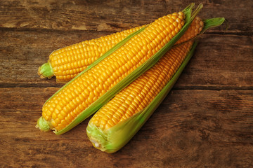 Fresh sweet corn on wooden background
