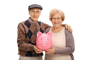 Happy seniors with a piggybank