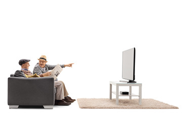 Seniors on a sofa watching television