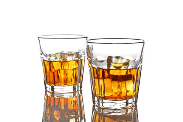 Glasses of whisky with ice isolated on white