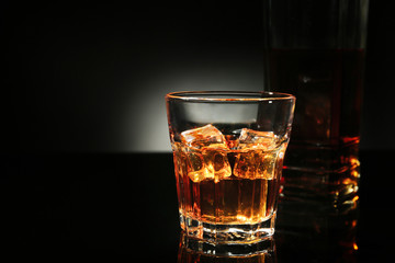 Glass of whisky on dark background