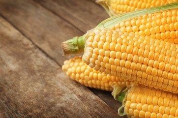 Corncobs on wooden rustic table, closeup
