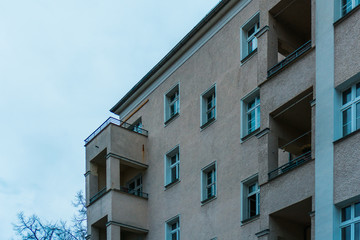 orange facaded apartment building with balcony on the corner