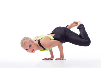 Attractive female gymnast exercising at studio