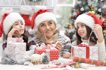 Grandmother with girls celebrating Christmas