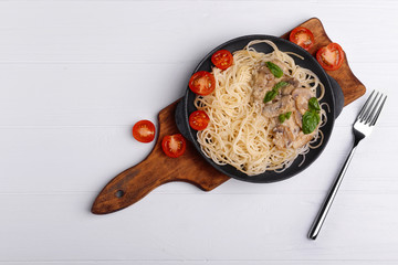 Pasta with mushrooms sauce in pan, top view