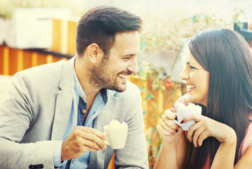 Happy Couple Having A Cup of Coffee in a Restaurant