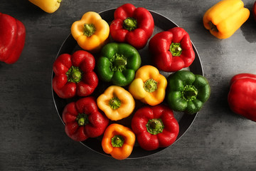 Red, green and yellow sweet bell peppers on table, top view
