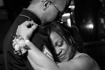 Happy groom kisses his crying mother embracing her tender