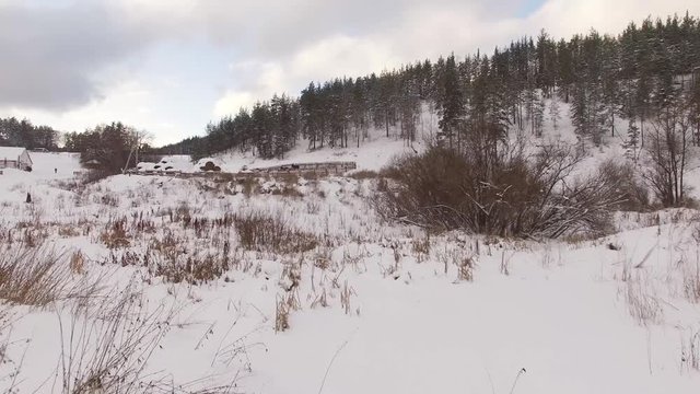 Panoramic aerial view of a farm for breeding horses in winter.