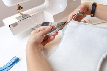 Obraz na płótnie Canvas Sewing machine with woman close-up