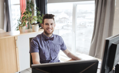 happy creative male office worker with computer