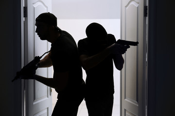 Thieves with gun entering the room