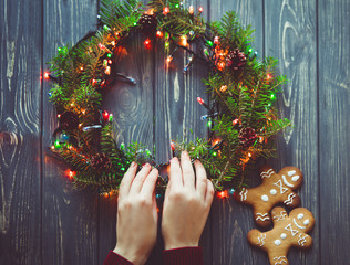 Christmas preparing process. Woman decorate beautiful wreath
