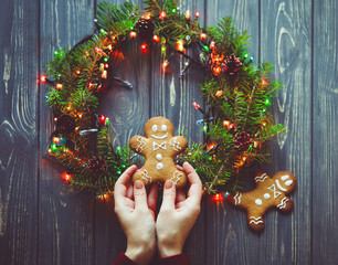 Simple Christmas gingerbread in woman hands 
