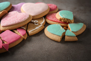 Tasty colourful heart shaped cookies on grey background