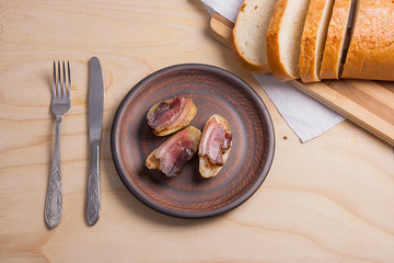 Baked potatoes with slices of bacon on wooden background. Slices