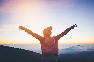 Silhouette Freedom woman standing with raised arms and enjoying