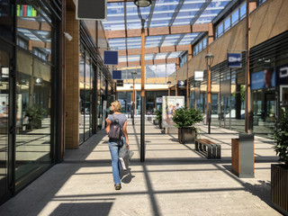 Woman with a bag walking in shopping mall