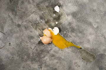 Egg fall and broken on concrete floor , top view