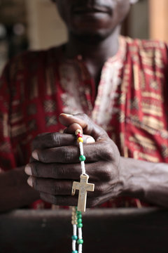African man praying the rosary, Cotonou, Benin, West Africa